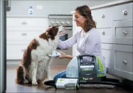  ?? BISSELL VIA AP ?? This undated photo provided by Bissell shows their Bissell BarkBath Portable Dog Bath. Less water used and less mess to contend with make the BarkBath appealing to those with minimal space and/or pets who are bath-averse. The system, similar to a...