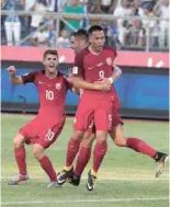  ?? — Reuters ?? USA’s Bobby Wood (9) is congratula­ted by teammates after scoring.