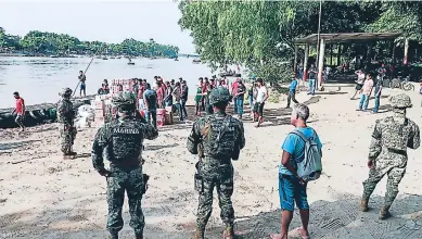  ?? Afp ?? PRESENCIA. Un grupo de efectivos de la Marina mexicana resguardan la orilla del río Suchiate en Ciudad Hidalgo, estado de Chiapas, en la frontera con Guatemala.