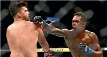  ?? AP ?? Israel Adesanya defeated Kelvin Gastelum to set up a middleweig­ht unificatio­n bout against Robert Whittaker.