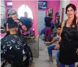  ??  ?? Beautician­s cut hair and paint nails at one of Santa Clara’s small salons.