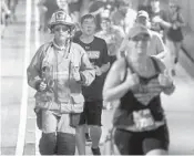  ?? MIKE STOCKER/SUN SENTINEL ?? Driver/engineer Josh Cohen runs through the Henry E. Kinney Tunnel during the Tunnel to Towers 5K Run &amp; Walk.