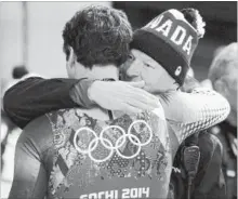  ?? CANADIAN PRESS FILE PHOTO ?? Canada’s Sam Edney, left, is consoled following his team’s fourth-place finish in the luge team relay at the Sochi Winter Olympics in 2014.