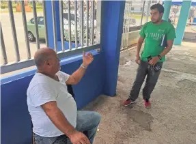  ?? RICK JERVIS/USA TODAY ?? Antonio Torres, left, head of the fishermen's associatio­n in Punta Santiago, Puerto Rico, talks with Carlos Ayala, a volunteer with the nonprofit Foundation for Puerto Rico. Torres says recovery in Punta Santiago has come mostly at the hands of volunteers such as Ayala.