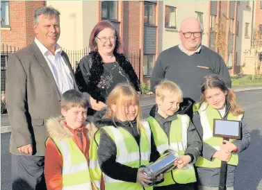  ??  ?? Pupils from Christ Church & St Peter’s CE Primary School in Mountsorre­l have been creating posters and stories about their lives to bury in a time capsule at brand new Rothley care home, Mountview. Pictured, back row from left: Paul Farmer (managing...