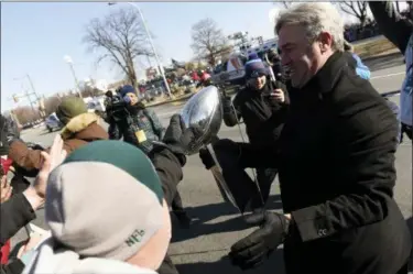  ?? MICHAEL PEREZ - THE ASSOCIATED PRESS ?? A fan reaches out to touch the Lombardi Trophy carried by Eagles head coach Doug Pederson during the Super Bowl LII victory parade, Thursday, in Philadelph­ia.