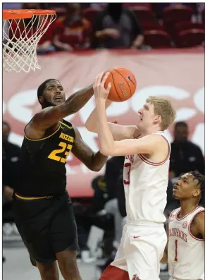  ?? (NWA Democrat-Gazette/Andy Shupe) ?? Arkansas forward Connor Vanover (right) has his shot blocked by Missouri forward Jeremiah Tilmon during the first half Saturday at Walton Arena in Fayettevil­le. Vanover was 0 of 11 from the field, and the Razorbacks were 19 of 71 (26.8%) in an 81-68 loss, their first of the season. More photos at arkansason­line.com/13uamu/