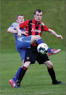  ??  ?? North End’s Keith Kearney stretches a leg to get a boot to the ball ahead of Thomas O’Rourke of Cherry Orchard.