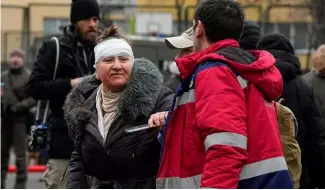  ?? ?? A medical worker helps a woman in a yard of an apartment building destroyed after Russian attack in Kyiv, Ukraine, Wednesday, Feb. 7, 2024.