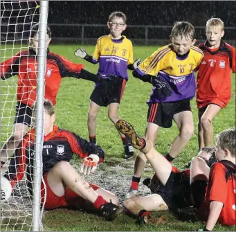  ??  ?? Jack Cleary (10) scoring a goal for Bannow despite the best efforts of the Oulart defenders.