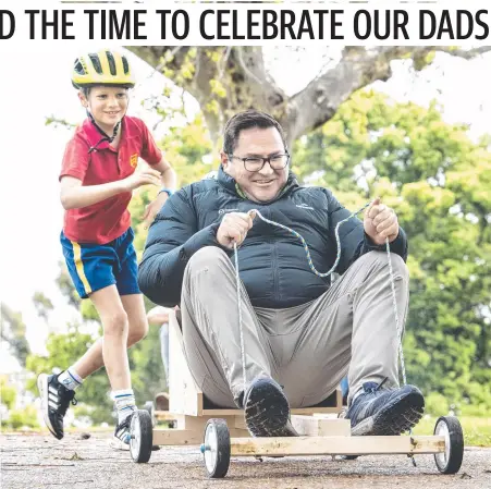  ?? Picture: Nev Madsen ?? CART RACE: BJ Russell pushes off his dad David Russell at the Toowoomba Grammar School annual billy kart race.