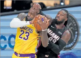 ?? AP ?? Los Angeles Lakers forward LeBron James and Miami Heat forward Jae Crowder battle for a rebound during Game 4 of the NBA Finals on Tuesday night.