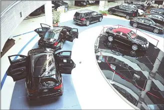  ?? (AFP) ?? This file photo shows imported cars displayed at a showroom in Qingdao Internatio­nal Auto Mall in Qingdao in China’s eastern Shandong province. China announced on May 22 that it would cut tariffs on auto imports from July
1, the latest sign of a thaw...