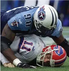  ?? JEFF HAYNES/GETTY IMAGES FILE PHOTO ?? Fans — and maybe QB Rob Johnson (sacked by Jevon Kearse) — wished the Bills had started Doug Flutie in the 1999 wild-card game.