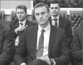  ?? Evgeny Feldman/AP ?? Navalny: Russian opposition leader Alexei Navalny, who submitted endorsemen­t papers necessary for his registrati­on as a presidenti­al candidate, center, sits at the Russia's Central Election commission in Moscow, Russia, Monday. Russian election...