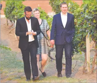  ?? JOE FRIES/Penticton Herald ?? Conservati­ve Leader Andrew Scheer, right, and his wife, Jill, are led by Marshall Neufeld to an event Monday at Lang Vineyards in Naramata.