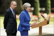  ?? TIM IRELAND - THE ASSOCIATED PRESS ?? British Prime Minister Theresa May speaks watched by her husband Philip in 10 Downing street, London, as she addresses the press Friday, following an audience with Britain’s Queen Elizabeth II at Buckingham Palace where she asked to form a government....