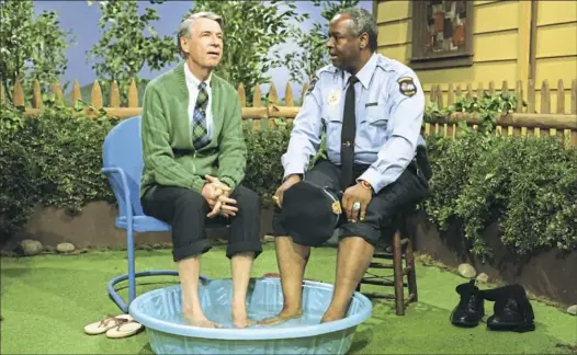  ?? John Beale ?? Fred Rogers, left, with Francois Clemmons from the show “Mister Rogers’ Neighborho­od” in the film “Won’t You Be My Neighbor?”