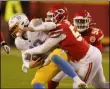  ?? CHARLIE RIEDEL - THE ASSOCIATED PRESS ?? Los Angeles Chargers quarterbac­k Justin Herbert is sacked by Kansas City Chiefs defensive end Alex Okafor, right, during the second half of an NFL football game, Sunday, Jan. 3, 2021, in Kansas City.