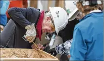  ?? JASON FRANSON / THE CANADIAN PRESS ?? Former President Jimmy Carter helps build homes for Habitat for Humanity in Edmonton, Alberta. Carter was back at a Habitat for Humanity worksite Friday, a day after he was hospitaliz­ed for dehydratio­n.