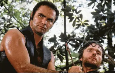  ?? Associated Press ?? In one of his most iconic roles, Burt Reynolds, with Bill McKinney, joined three friends on a deadly river adventure in the 1972 film “Deliveranc­e.”