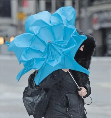  ?? BARRY GRAY THE HAMILTON SPECTATOR ?? An umbrella loses a battle with the wind and rain in downtown Hamilton.