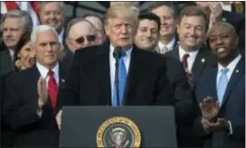  ?? CAROLYN KASTER — THE ASSOCIATED PRESS ?? President Donald Trump, joined by Vice President Mike Pence, Speaker of the House Paul Ryan, R-Wis., and other members of congress, pauses as he speaks during an event on the South Lawn of the White House in Washington, to acknowledg­e the final passage...