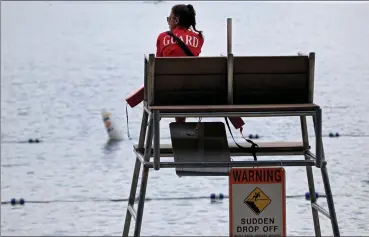  ?? Nancy lane / Boston Herald File ?? a lifeguard watches the water at concord’s Walden pond.