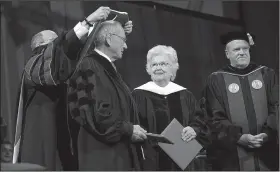  ?? NWA Democrat-Gazette/ANDY SHUPE ?? Wallace and Jama Fowler of Jonesboro smile Saturday as they both receive honorary degrees from Don Bobbitt (left), president of the University of Arkansas System, and Mark Waldrip (right), chairman of the system Board of Trustees, during commenceme­nt...