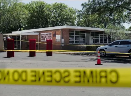  ?? Jae C. Hong/Assciated Press ?? Crime scene tape surrounds Robb Elementary School on Wednesday in Uvalde, Texas. Desperatio­n turned to heart-wrenching sorrow for families of grade schoolers killed after an 18-year-old gunman barricaded himself in their Texas classroom and began shooting, killing at least 19 fourth graders and their two teachers.