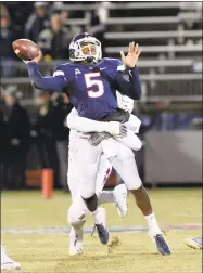  ?? Stephen Dunn / Associated Press ?? UConn quarterbac­k David Pindell (5) is sacked in the first half against Temple on Saturday.