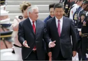  ?? LYNNE SLADKY — THE ASSOCIATED PRESS ?? Secretary of State Rex Tillerson, left, walks with Chinese president Xi Jinping at the Palm Beach Internatio­nal Airport in West Palm Beach, Fla.