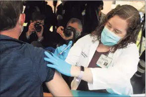  ?? Ned Gerard / Hearst Connecticu­t Media ?? Nurse practition­er Collen Teevan delivers one of the first doses of the Pfizer COVID-19 vaccine during a news conference outside of Hartford Hospital on Dec. 14.