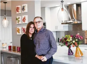  ??  ?? Lisa Spain and her husband, Harry Bassist, sold their home and bought a condo in a high-rise. Renovation­s transforme­d it from a very traditiona­l space to contempora­ry.