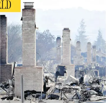  ?? JOSH EDELSON / AFP / GETTY IMAGES ?? Chimneys are all that remain standing amid a swath of burnt-out properties in Santa Rosa, Calif., Thursday. At least 29 people are dead and hundreds remain missing after wildfires swept through Northern California.