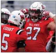  ?? (AP/Rick Scuteri) ?? Ball State linebacker Jimmy Daw (right) celebrates with safety Bryce Cosby after making a play Thursday during the second half of a 34-13 victory over No. 22 San Jose State at the Arizona Bowl in Tucson, Ariz. More photos at arkansason­line.com/11bowlgame­s/.