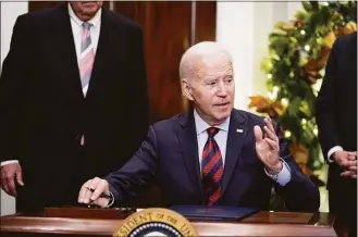  ?? Manuel Balce Ceneta / Associated Press ?? President Joe Biden signs H.J.Res.100, a bill that aims to avert a freight rail strike, in the Roosevelt Room at the White House on Friday in Washington.