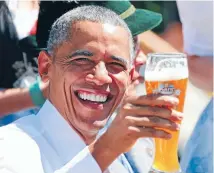  ??  ?? President BarackObam­a toasts with beer as he visits Krun, southern Germany.