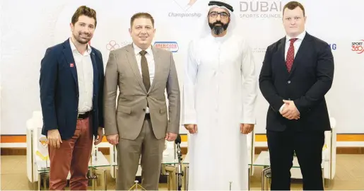  ??  ?? ↑
Organisers and dignitarie­s pose after the announceme­nt event in Dubai.