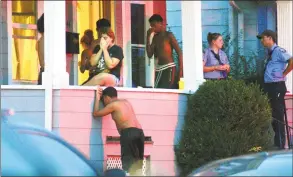  ?? Christian Abraham / Hearst Connecticu­t Media ?? Family and friends gather on a porch after a 2-year-old was pulled from a backyard pool on Thursday. The child died at a local hospital, officials said. The child was taken out of the water from a residence on Charron Street in Bridgeport around 7:25 p.m.