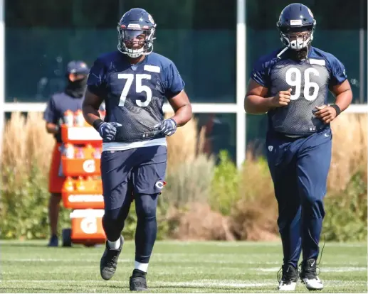  ?? KAMIL KRZACZYNSK­I/AP ?? The Bears’ Akiem Hicks (right, with fellow defensive lineman Trevon McSwain on Thursday at Halas Hall) says he’s ready for the season to begin.