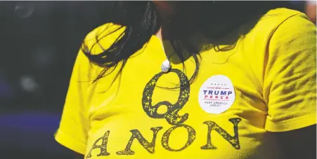  ?? ELIJAH NOuvELAGE/ REUTERS FILES ?? A supporter of U.S. President Donald Trump wears a QAnon shirt in Adairsvill­e, Ga., last month. The QAnon cult has become a household name and an issue in the U.S. election, despite its crackpot theories and belief that Trump is a messiah, says Diane Francis.