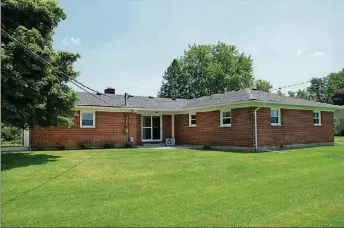  ??  ?? Patio doors off the family room open to a concrete patio that was new about 5 years ago. The patio overlooks the open backyard as the brick ranch sits on just under an acre with no rear neighbors.