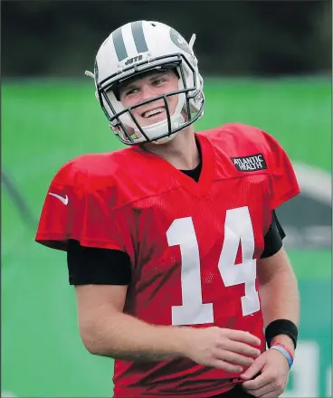  ?? — AP PHOTO ?? After signing a big contract, Jets rookie quarterbac­k Sam Darnold was all smiles Monday during a practice at the team’s training camp in Florham Park, N.J.