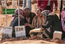  ?? Emrah Gurel/Associated Press ?? People mourn at a cemetery Friday as they bury their loved ones, victims of the Monday earthquake in Adiyaman, Turkey.