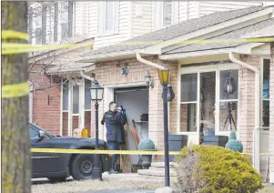  ?? CP PHOTO ?? A forensic investigat­or takes photograph­s at a home in Ajax, Ont., on Thursday.