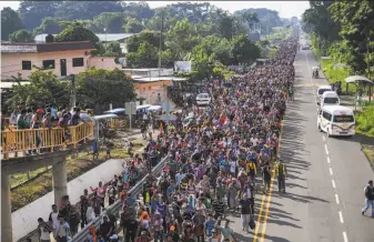  ?? Pedro Pardo / AFP / Getty Images ?? Central American migrants walk together in southern Mexico on a road to Tapachula on their long march toward the U.S. border. President Trump says they will not be allowed to enter.