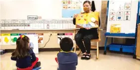  ?? ASHLEE REZIN GARCIA/SUN-TIMES ?? Pre-kindergart­en teacher Angela Panush reads a story to her students at Dawes Elementary on Monday.