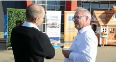  ??  ?? Hutchinson Builders area manager Rob Weymouth and FKG Group executive chairman Gary Gardner discuss their companies' respective designs for cubby houses.