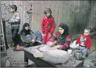  ?? [SYRIAN DAMASCUS MEDIA CENTER] ?? A Syrian woman makes bread in an undergroun­d shelter as she seeks protection for her family from government attacks.